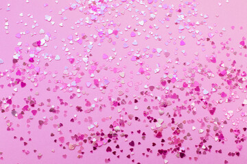 Abstract background of pink heart-shaped sparkles.