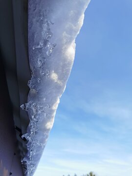 Sople lodu zwisające z dachu zimą