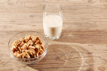 Healthy food - a glass of milk and a quick breakfast in a plate are on a wooden table.
