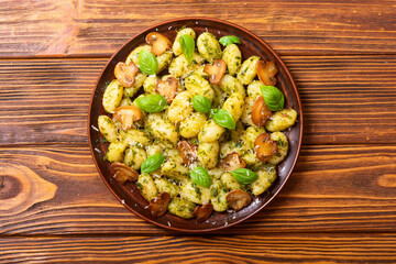 Homemade potatoes gnocchi with basil , cheese and mushrooms