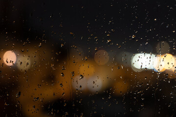 rain on window and lights of the torches