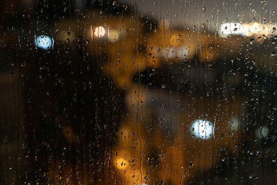 rain on window and lights of the torches
