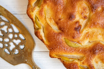 Homemade fresh apple pie on a white wooden background. View from above. Food background.