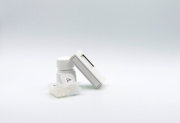 PILLS, MEDICINES AND PILLBOX ON A WHITE BACKGROUND