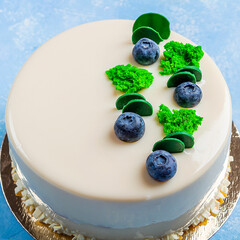 Homemade uncut blueberry vegan cake decorated with white frosting, cream and fresh berries. Birthday or festive sponge pie on dark background.