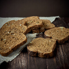 black bread on a wooden table on a coarse cloth with