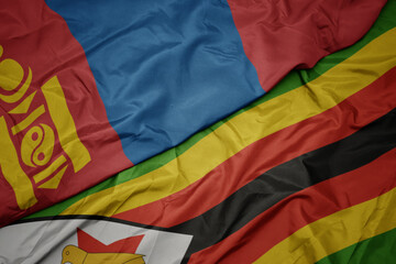 waving colorful flag of zimbabwe and national flag of mongolia.