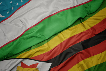waving colorful flag of zimbabwe and national flag of uzbekistan.