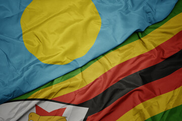 waving colorful flag of zimbabwe and national flag of Palau .