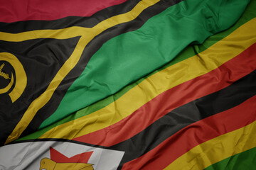 waving colorful flag of zimbabwe and national flag of Vanuatu .