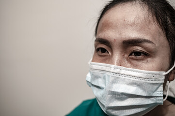 Close up asian doctor woman wear mask for protect covid-19 virus,She sad and stress about work a lot