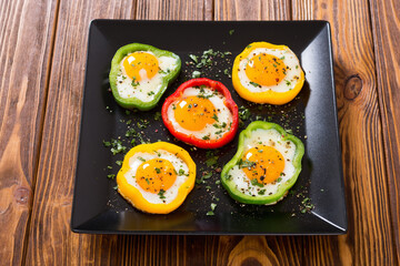 Fototapeta na wymiar Yellow , red and green pepper with fried eggs