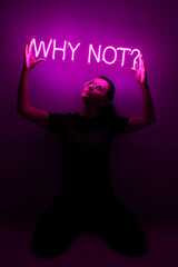 Beautiful young girl holding pink neon sign why not?. Trendy style. Neon sign. Custom neon. Home decor.