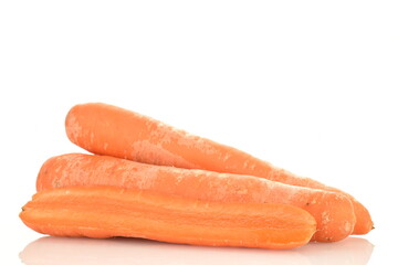 One half and two whole ripe organic, unpeeled carrots, close-up, isolated on white.