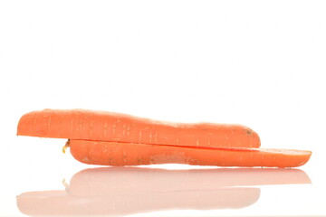 One ripe organic, unpeeled carrot, cut in half, close-up, isolated on white.
