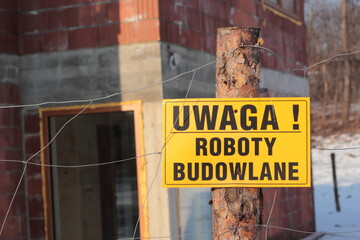 Sign in Polish "Uwaga! Roboty budowlane" (Caution! Construction area). © Anna