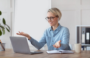 Online learning during covid-19. Friendly female teacher giving web lesson, chatting with students, space for design