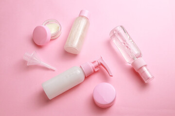 Bottles with cosmetic for facial and body care on light background