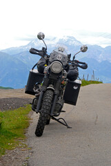 front view of adventure bike   motorcycle with alps in the background