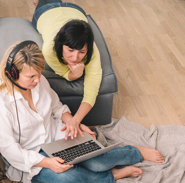 Two Women Communicate Online Via Videoconferencing. Distance Learning At Home Concept