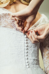 Wedding morning fastens the bride's corset