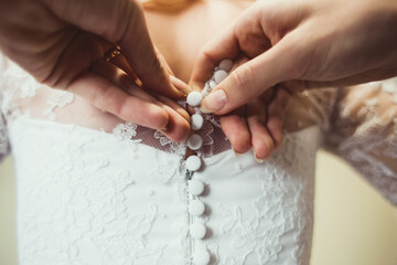 Wedding morning fastens the bride's corset