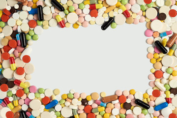 the frame is lined with colored tablets, pills and capsules. Isolated