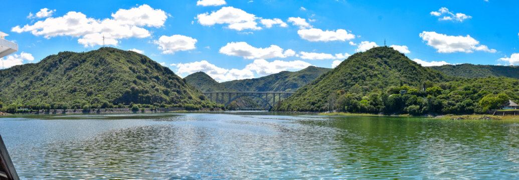 panoramic lake san roque villa Carlos paz with a wonderful blue sky and crystal clear water with the jose manuel de la sota bridge