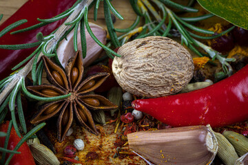 Spices and seasonings, spilled on a table as a background.