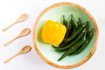 Yellow bell pepper and green pepper on the white background, colorful vegetables, raw ingredients