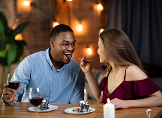 Sweet Moments. Interracial Couple Having Fun During Romantic Date In Restaurant