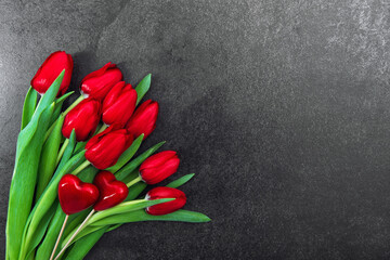 Red hearts tulip flowers dark background Valentines Day decoration