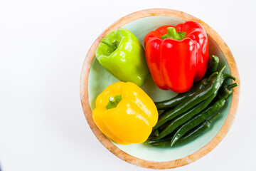 All colors bell pepper and green pepper in the bowl on the white background,
