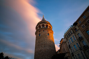 Naklejka premium long exposure photo of Galata Tower at sunset with motions of clouds. Galata Tower background photo. Travel to Istanbul. Istanbul background photo.