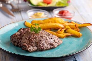 steak on a plate with french fries