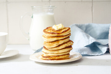 Fluffy breakfast pancakes with maple syrup and berries