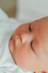 Close-up. Baby. Beautiful young happy mom and baby. Mom holds the baby in her arms.