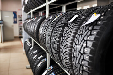 assortment of tires for car in repair garage, replacement of winter and summer tires. seasonal tire...