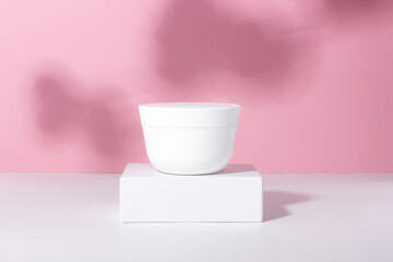 White tube of cosmetic products on a stand. Plastic container for cream, lotion, face mask. The concept of environmentally friendly, organic cosmetology.