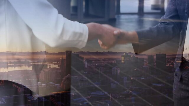 Digital composition of business people shaking hands over globe against cityscape in background