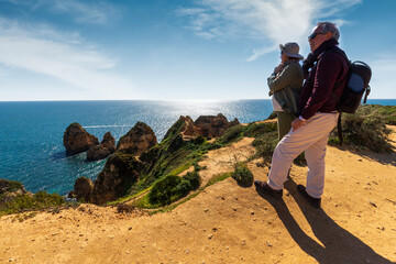 senior couple walking on the beach