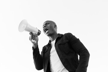 From below of cheerful African American male shouting in loudspeaker while standing on white background