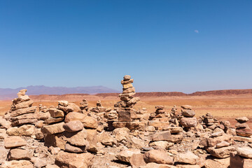Fototapeta na wymiar red rocks cairns in the desert