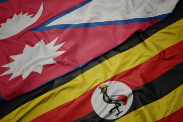 waving colorful flag of uganda and national flag of nepal.