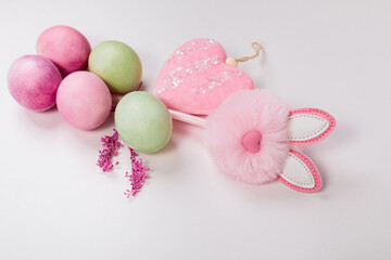 Multi-colored eggs with twigs, on a white background with a place for text.