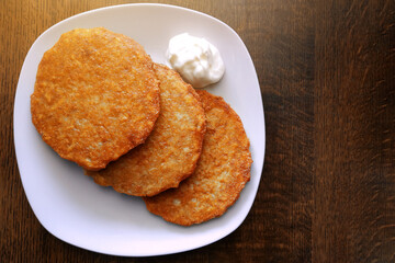 Crispy fried potato pancakes, vegetarian food, potato dish.