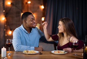 Cheerful Interracial Couple Having Fun During Romantic Dinner At Home