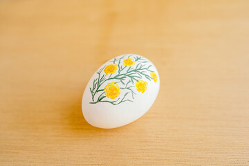 Top view of chicken egg painted with aquarelle placed on table for Easter