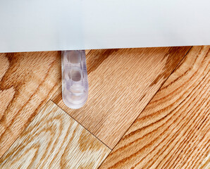 Translucent rubber home door stopper or slider on red oak floor