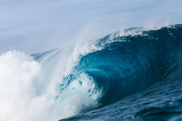 Powerful foamy sea waves rolling and splashing over water surface against cloudy blue sky